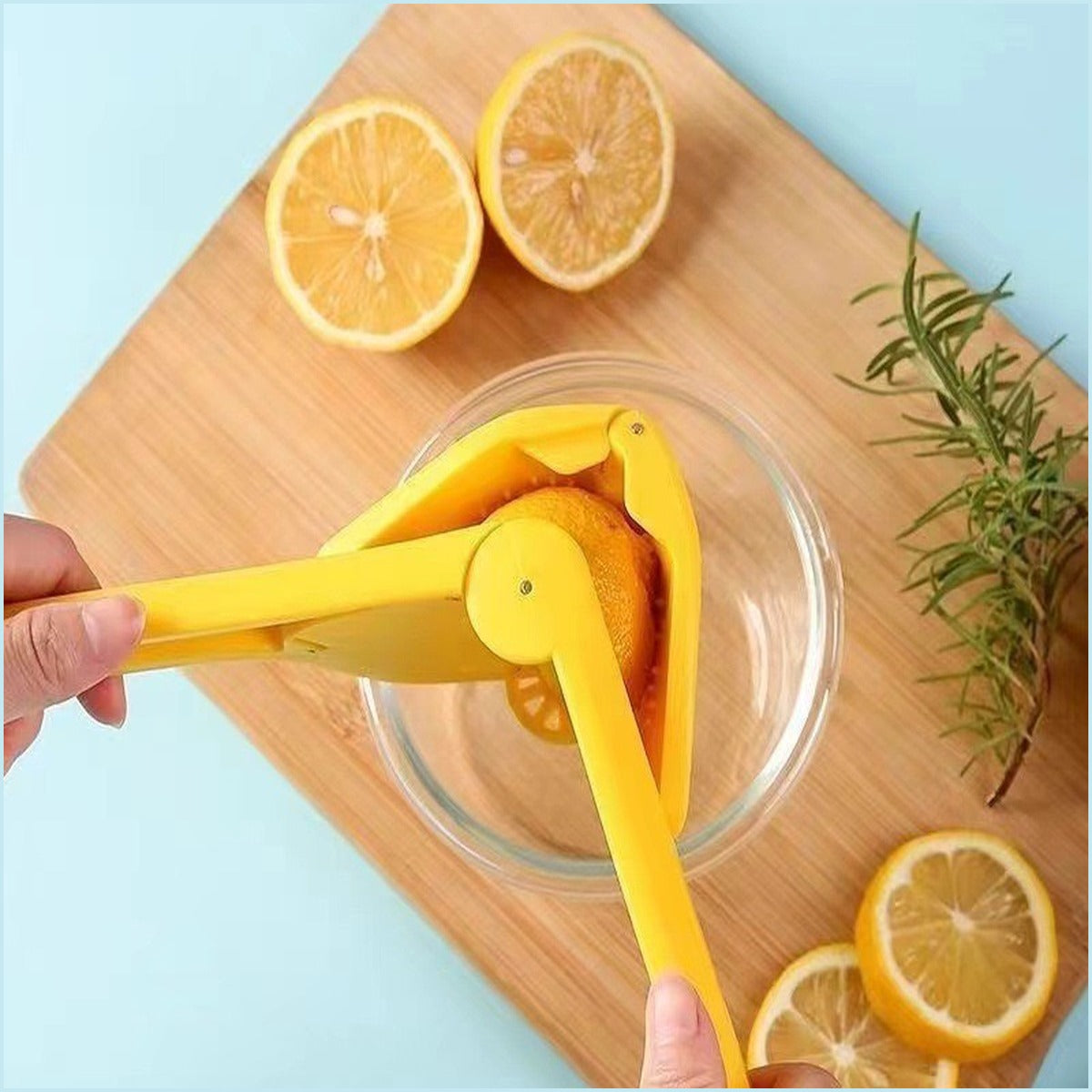 Manual citrus juicer pressing lemon into bowl